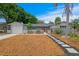 Inviting home with a well-manicured front yard, decorative fence, and a pathway leading to the red front door at 8407 Granite Pl, Tampa, FL 33615