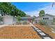 Charming home with a well-manicured front yard, decorative fence, and a pathway leading to the red front door at 8407 Granite Pl, Tampa, FL 33615