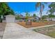 Well-maintained home with a spacious driveway, modern landscaping, and a charming pathway to the entrance at 8407 Granite Pl, Tampa, FL 33615