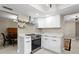 A modern kitchen featuring white cabinetry, stainless steel appliances, and quartz countertops at 8407 Granite Pl, Tampa, FL 33615