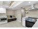 A modern kitchen featuring stainless steel appliances, white cabinetry, and a breakfast nook at 8407 Granite Pl, Tampa, FL 33615