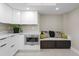 Stylish kitchen nook with white cabinets, stainless steel microwave, and a comfortable seating area at 8407 Granite Pl, Tampa, FL 33615