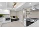 A modern kitchen featuring white cabinetry, stainless steel appliances, and tile flooring at 8407 Granite Pl, Tampa, FL 33615