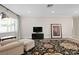 Inviting living room featuring a cozy armchair and a decorative area rug at 8407 Granite Pl, Tampa, FL 33615