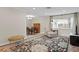 Inviting living area with a large rug, comfortable seating, and a dining set creating a cozy and functional space at 8407 Granite Pl, Tampa, FL 33615