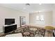 Spacious living room with stylish rug, a TV stand, and a charming stool, blending comfort and functionality at 8407 Granite Pl, Tampa, FL 33615