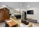 Living area with sofa, armoire, kitchenette, refrigerator, and wooden table and chairs at 8407 Granite Pl, Tampa, FL 33615