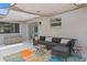 Outdoor patio featuring awning, neutral colored lounge furniture, and colorful area rug at 8407 Granite Pl, Tampa, FL 33615