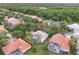 A beautiful neighborhood is seen from this aerial shot, complete with mature trees, manicured lawns, and a screened-in lanai at 10232 Estuary Dr, Tampa, FL 33647