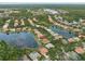 Community aerial showcasing waterfront homes nestled among mature trees and lush landscaping, offering serene lakeside living at 10232 Estuary Dr, Tampa, FL 33647