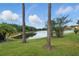 Lake view with mature trees and manicured lawn at 10232 Estuary Dr, Tampa, FL 33647