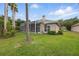 Enjoy the outdoor living in this home's backyard featuring a screened lanai and views of the surrounding greenery at 10232 Estuary Dr, Tampa, FL 33647