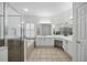 Spacious bathroom with a glass-enclosed shower, bathtub, and vanity area at 10232 Estuary Dr, Tampa, FL 33647