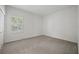 Neutral carpeted bedroom with white walls and natural light from window at 10232 Estuary Dr, Tampa, FL 33647