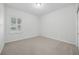 Clean and well-lit bedroom with a window and neutral carpeting at 10232 Estuary Dr, Tampa, FL 33647