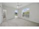 Bright bedroom with a ceiling fan and arch window overlooking outdoors at 10232 Estuary Dr, Tampa, FL 33647
