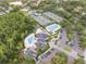 Aerial view showcasing community amenities: pools, tennis courts, clubhouse, ample parking, and lush landscaping all around at 10232 Estuary Dr, Tampa, FL 33647