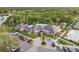 Upscale community clubhouse featuring a covered entrance, lush landscaping, ample parking, and a welcoming porte cochere at 10232 Estuary Dr, Tampa, FL 33647