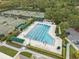 Aerial view of the community pool featuring lap lanes, lounge areas, shade structures, and professionally landscaped areas at 10232 Estuary Dr, Tampa, FL 33647