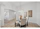 Bright dining area featuring a glass table, four chairs, and modern light fixture at 10232 Estuary Dr, Tampa, FL 33647