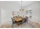 Elegant dining room with a wooden table, stylish chairs, and a modern chandelier at 10232 Estuary Dr, Tampa, FL 33647