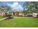 Charming single-story home with a tile roof, well-maintained landscaping, and lush green lawn at 10232 Estuary Dr, Tampa, FL 33647