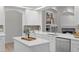 Bright kitchen with white cabinets, island, stainless steel appliances, and designer fixtures at 10232 Estuary Dr, Tampa, FL 33647
