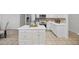 Modern eat-in kitchen featuring an island, white cabinets, and stainless steel appliances at 10232 Estuary Dr, Tampa, FL 33647