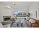 Inviting living room with fireplace, brown leather sofa, and large sliding doors to the backyard at 10232 Estuary Dr, Tampa, FL 33647