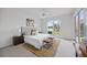 Serene main bedroom featuring a plush bed, decorative pillows, and a view of the lake at 10232 Estuary Dr, Tampa, FL 33647
