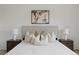 Well-lit main bedroom showcasing a decorative headboard, side tables, and lamps at 10232 Estuary Dr, Tampa, FL 33647