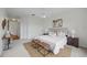 Comfortable main bedroom with a large bed, accent seating, and doorway access to the hall at 10232 Estuary Dr, Tampa, FL 33647