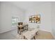 Bright office space with a rustic desk, comfortable chairs, and natural light from the window at 10232 Estuary Dr, Tampa, FL 33647
