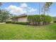 Landscaped backyard with lush green grass and well-maintained shrubbery bordering the perimeter of the property at 10232 Estuary Dr, Tampa, FL 33647