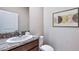 Bathroom featuring a granite countertop, single sink, framed art, and ample lighting at 10669 Bridgegate Heights Loop, San Antonio, FL 33576
