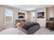 Comfortable bedroom with a neutral palette, two windows, and stylish decor, including unique wall art at 10669 Bridgegate Heights Loop, San Antonio, FL 33576