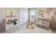 Bright Bedroom features a crib, changing table, rocking horse, and natural light from the window at 10669 Bridgegate Heights Loop, San Antonio, FL 33576