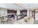 Spacious living room with modern furniture, stylish dining, and a dark wood kitchen featuring granite counters at 10669 Bridgegate Heights Loop, San Antonio, FL 33576