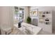 Well-lit office space featuring a white desk, bookshelf, decor, and a serene view from the window at 10669 Bridgegate Heights Loop, San Antonio, FL 33576