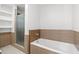 Bathroom with tile accents, a shower with a glass door, and built-in shelving at 111 N 12Th St # 1305, Tampa, FL 33602