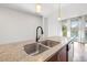Kitchen island with a granite countertop and a stainless steel sink at 111 N 12Th St # 1305, Tampa, FL 33602