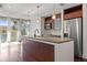 Modern kitchen features stainless steel appliances, wood cabinets, granite counters, and an oversized island at 111 N 12Th St # 1305, Tampa, FL 33602