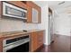 Bright kitchen featuring stainless appliances, wooden cabinetry, and modern backsplash at 111 N 12Th St # 1305, Tampa, FL 33602