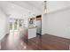 Modern kitchen features stainless steel appliances, wood cabinets, granite counters, an island, and overlooks the living space at 111 N 12Th St # 1305, Tampa, FL 33602