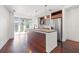 Modern kitchen features stainless steel appliances, wood cabinets, granite counters, and an oversized island at 111 N 12Th St # 1305, Tampa, FL 33602
