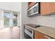 Well-equipped kitchen with modern stainless steel appliances and stylish tile backsplash at 111 N 12Th St # 1305, Tampa, FL 33602