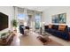 Bright living room featuring a modern sofa, stylish decor, and natural light at 111 N 12Th St # 1305, Tampa, FL 33602
