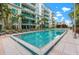 Community pool with sun loungers and lush landscaping at 111 N 12Th St # 1305, Tampa, FL 33602