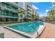Community pool surrounded by landscaping and lounge chairs at 111 N 12Th St # 1305, Tampa, FL 33602