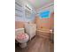 Charming bathroom with pink tiles, modern vanity, and unique toilet seat at 11447 Park Blvd # 301, Seminole, FL 33772